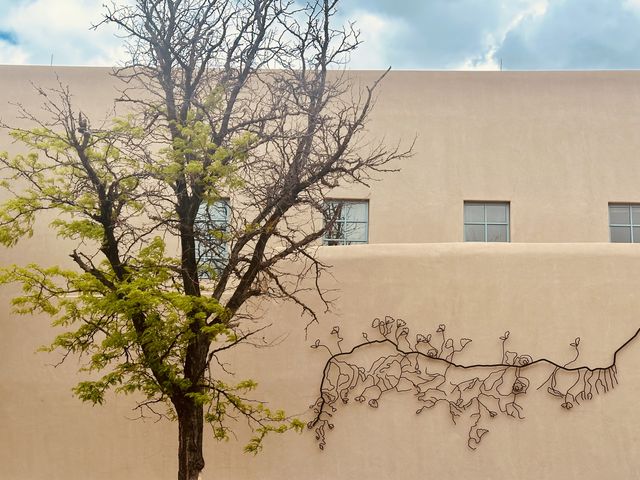Tree Beside Metal Vine Sculpture